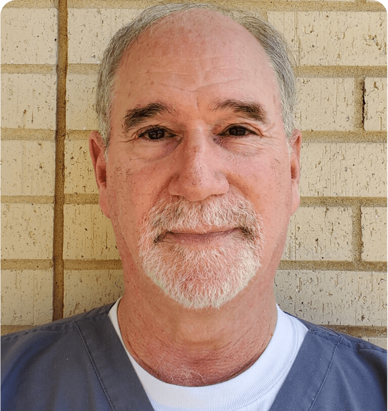 Man wearing grey shirt, neutral expression.