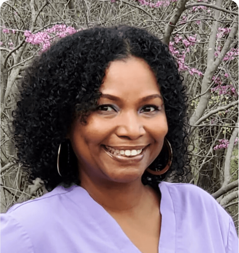 Smiling woman with curly hair outdoors